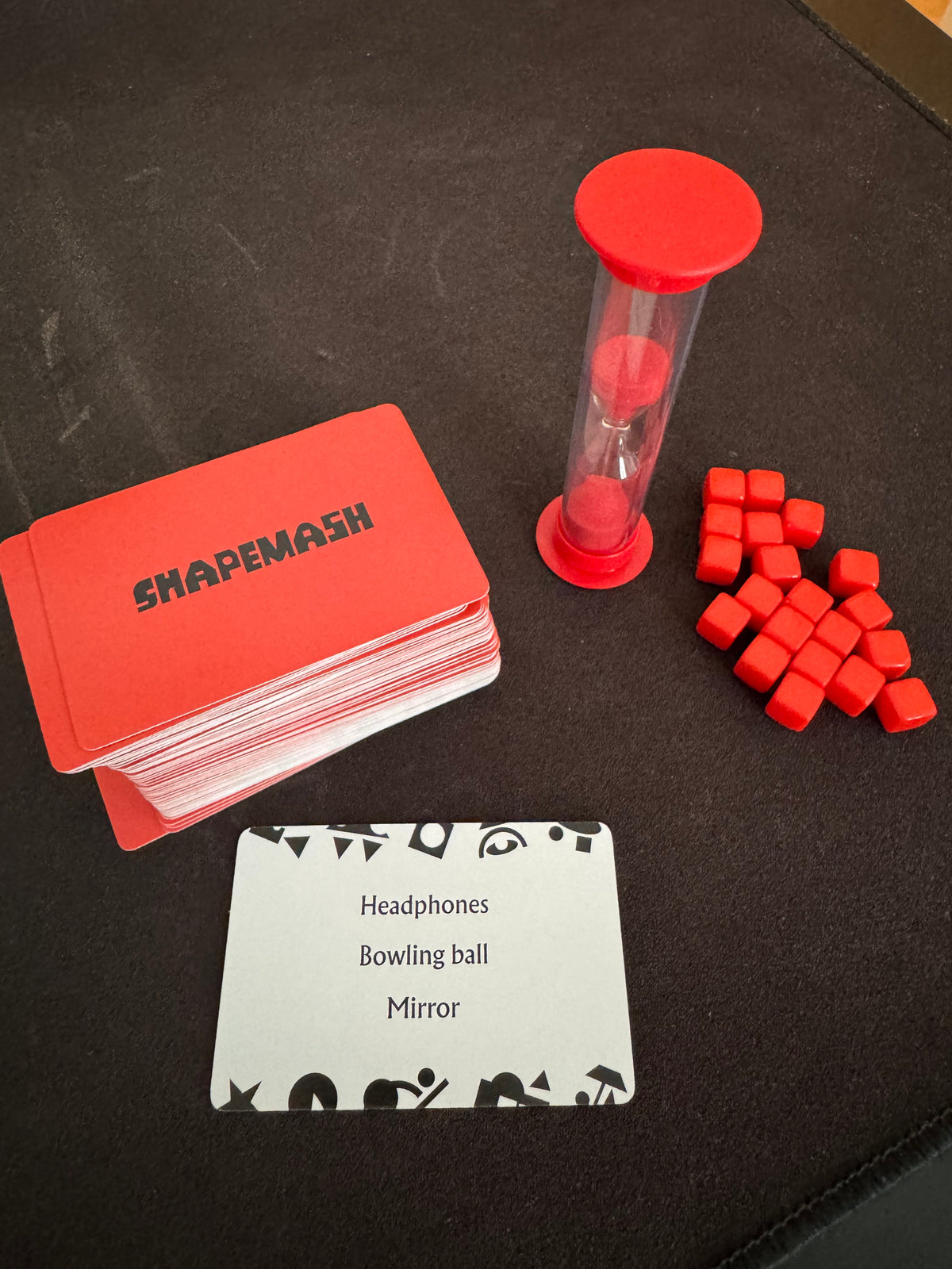 Shapemash word cards, sand timer and red scoring cubes