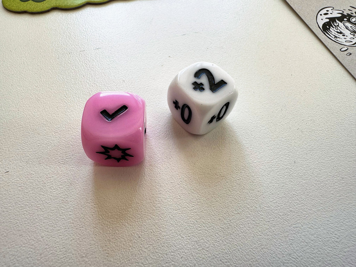The custom race die and damage die from Kitchen Rally